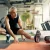 Active middle-aged man stretching in a modern gym, representing recovery and rejuvenation benefits of PRGF therapy in Farmington Hills